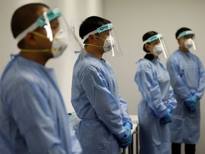 Security personnel dressed in PPE during the COVID-19 outbreak in Singapore April 24, 2020.