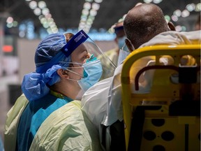 U.S. Army Sgt. Marlenny Medin asks a patient about his medical history at the Javits New York Medical Station (JNYMS) which supports local hospitals during the coronavirus disease (COVID-19) outbreak in New York City, U.S. April 8, 2020. Picture taken April 8, 2020.