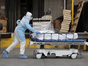 A healthcare worker wheels the body of a deceased person from the Wyckoff Heights Medical Center during the outbreak of the coronavirus disease (COVID-19) in the Brooklyn borough of New York City, New York, U.S., April 2, 2020.