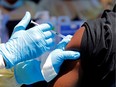 FILE PHOTO: A health worker injects a man with Ebola vaccine in Goma, Democratic Republic of Congo, August 5, 2019.