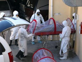 Workers of a funeral service show the process they carry out when working with victims of infectious diseases, in the face of the coronavirus COVID-19 pandemic, in Ciudad Juarez, Chihuahua State, Mexico, on April 7, 2020.