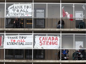 OTTAWA - April 24, 2020 - Residence of the Laurier Manor on Montreal Road get some fresh air on their balconies Friday.