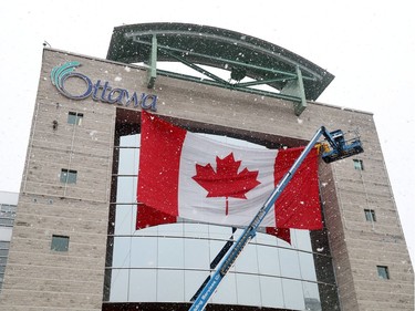 OTTAWA - April 9, 2020 - City installing a huge Canadian flag Thursday from the roof, outside City Hall to show Ottawa's solidarity in Canada's fight against Covid-19.