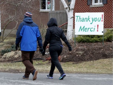 OTTAWA - April 9, 2020 - A lawn sign saying thank you to the essential service workers walking by their neighbourhood in Ottawa Friday.