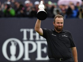 Ireland's Shane Lowry poses with the Claret Jug, the trophy for the Champion golfer of the year after winning the British Open at Royal Portrush in Northern Ireland on July 21, 2019.