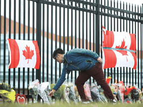 Files: A person leaves flowers at a make-shift memorial dedicated to Constable Heidi Stevenson at RCMP headquarters in Dartmouth, Nova Scotia, April 20, 2020.