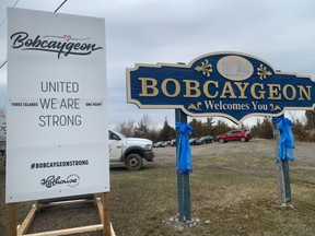 Bobcaygeon residents place a poster saying 'United We're Stong' next to the sign, after 29 residents of PineCrest succumbed to COVID-19.