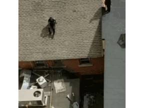 Screen grab from Ottawa Police Services video clip
of Sgt. Jason Riopel responding to a call about an unconscious woman on a rooftop.
