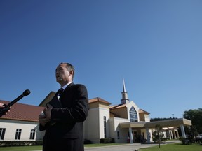Pastor Tony Spell talks with journalists before attending Sunday service at the Life Tabernacle megachurch challenging state orders against assembling in large groups to prevent the spread of coronavirus disease (COVID-19) in Baton Rouge, Louisiana U.S., April 5, 2020.