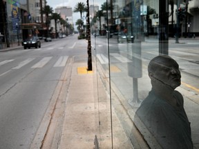 A local resident waits for the bus as the spread of the coronavirus disease (COVID-19) continues, in New Orleans, Louisiana U.S., April 7, 2020.