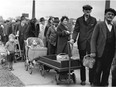 In this May 9, 1938 file photo, people stand in line for their portions of a federal surplus of potatoes and cabbages in Cleveland.