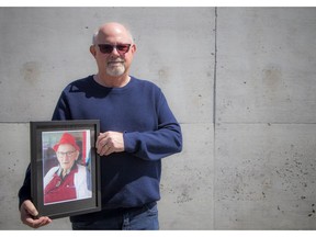 Ken Williams holds a photo of his father, 95-year-old Ken Williams, who died on Friday from Covid-19 at the Madonna Care Community.