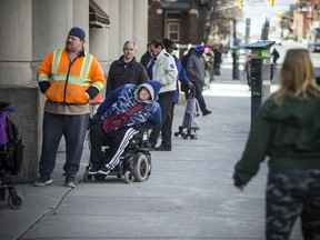 People line up on Somerset Street down to Kent Street, waiting to do their groceries at Massine's Your Independent Grocer last month.