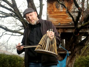 Carleton University music professor Jesse Stewart plays a water phone outside of his Ottawa home. He plays a variety of odd percussion instruments.