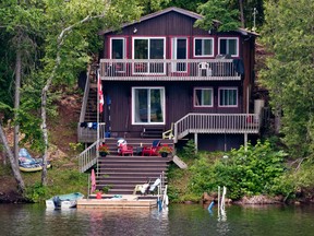 Cottage with stairs leading to the water.