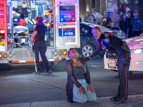 Photographer Wayne Cuddington was the winner of the Breaking News Photo award for a photo of a police officer attending to a woman in distress after a man was shot and killed in the ByWard Market.