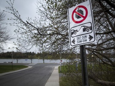 OTTAWA -- May 9, 2020 -- Small numbers braved the wild weather Saturday May 9, 2020, to see the start of the blooming tulips at The Canadian Tulip Festival in Commissioners Park. No parking on the weekend signs were posted up and down all the side streets around Dow's Lake.