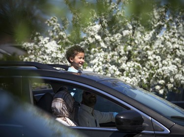 OTTAWA -- May 23, 2020 -- Three-year-old Habib Hawhaqi peeked out the sunroof of his families vehicle during a special drive-in Eid prayer that was held at the Ottawa Mosque on Northwestern Ave, Saturday, May 23, 2020.