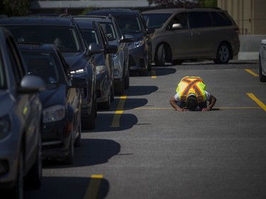 A volunteer prayed during a special drive-in Eid prayer that was held at the Ottawa Mosque on Northwestern Ave, Saturday, May 23, 2020.