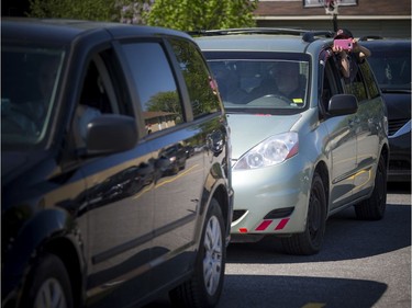 OTTAWA -- May 23, 2020 -- A young boy peeked out of his families vehicle during a special drive-in Eid prayer that was held at the Ottawa Mosque on Northwestern Ave, Saturday, May 23, 2020.