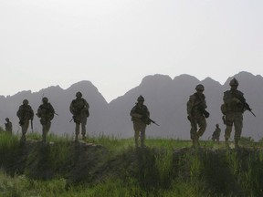 Canadian soldiers patrol an area in the Dand district of southern Afghanistan in 2009.