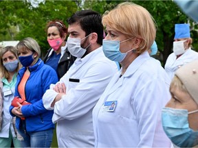 Doctors and nurses rally outside a Kiev hospital on May 6, 2020, to protest against a decrease in their salaries as a result of the ongoing medical reform, as the country is under lockdown to stop the spread of the Covid-19 pandemic caused by the novel coronavirus.