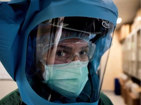 A nurse puts on his Personal Protective Equipment (PPE) before starting to work at the intensive care unit, treating COVID-19 patients, of the Tor vergata hospital in Rome, on May 12, 2020, as the country is under lockdown to stop the spread of the Covid-19 disease caused by the novel coronavirus.