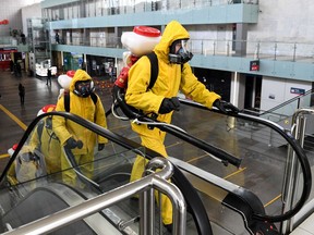 Servicemen of Russia's Emergencies Ministry wearing protective gear disinfect Moscow's Leningradsky railway station on May 19, 2020.