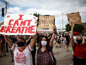 Protesters demonstrate in a call for justice for George Floyd following his death, outside the 3rd Police Precinct on May 27, 2020 in Minneapolis, Minnesota.
