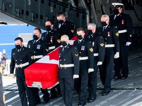 Masked military pallbearers carry the casket of Sub-Lt. Abbigail Cowbrough during a repatriation ceremony for the six Canadian Forces personnel killed in a military helicopter crash in the Mediterranean at Canadian Forces Base in Trenton, Ontario, May 6, 2020.