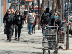 People walk along Ste. Catherine street in Montreal, May 14, 2020.