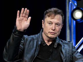 Elon Musk, founder of SpaceX and chief executive officer of Tesla Inc., waves while arriving to a discussion at the Satellite 2020 Conference in Washington, D.C., U.S., on Monday, March 9, 2020.