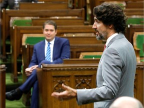 Prime Minister Justin Trudeau speaks to the special committee on the COVID-19 outbreak as Andrew Scheer, leader of the Official Opposition, looks on in a near-empty House of Commons.
