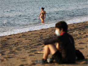 People enjoy the sunny weather on the Barceloneta beach amidst the easing of restrictions implemented to curb the spread of the coronavirus disease (COVID-19), in Barcelona, Spain May 8, 2020.