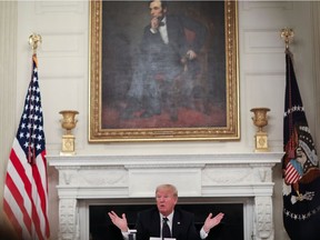 U.S. President Donald Trump talks about taking daily doses of hydroxychloroquine pills as he addresses a coronavirus disease (COVID-19) pandemic meeting with restaurant executives and industry leaders beneath a portrait of President Abraham Lincoln in the State Dining Room at the White House in Washington, U.S., May 18, 2020.
