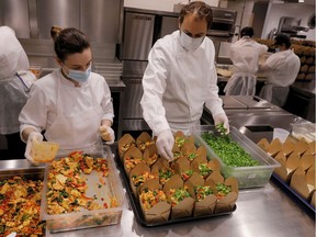 Chef and owner Daniel Humm works to fill to-go boxes of food to donate in the kitchen of Michelin starred restaurant Eleven Madison Park as the outbreak of the coronavirus disease (COVID19) continues in the Manhattan borough of New York, U.S., May 20, 2020.