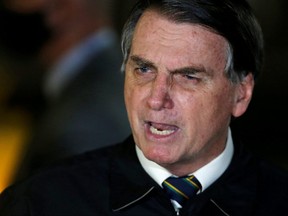 Brazil's President Jair Bolsonaro speaks with journalists as he arrives at Alvorada Palace, amid the coronavirus disease (COVID-19) outbreak, in Brasilia, Brazil, May 22, 2020.