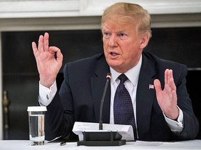 U.S. President Donald Trump reveals he is taking hydroxychloroquine, during a meeting with restaurant executives in the White House in Washington, D.C., U.S., on Monday, May 18, 2020.