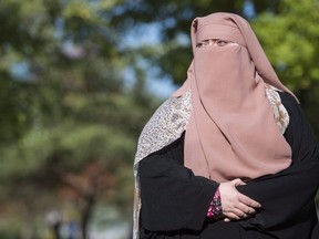 Warda Naili poses for a photograph at a park in Montreal, Saturday, October 21, 2017. Three years ago, Warda Lacoste was at the centre of a fight against Quebec's attempt to ban religious face coverings for people who were giving or receiving public services. The Montreal woman says she was spat on, verbally harassed and even had a bottle of beer thrown at her when she was out in public wearing a full-face veil, known as a niqab, in that time of heightened tensions. Lacoste (who previously went by the surname Naili) said the experience marked her. "It was quite a challenge," she said in a recent interview. These days, Lacoste, 36, said there is something strange about seeing Quebec Premier Francois Legault urge Quebecers to cover their faces in public to prevent the spread of the novel coronavirus. Lacoste recognizes the COVID-19 crisis is real in Quebec, which has recorded more than half of all the confirmed cases in Canada. "But of course, we can't ignore that the situation has an ironic side," she said.