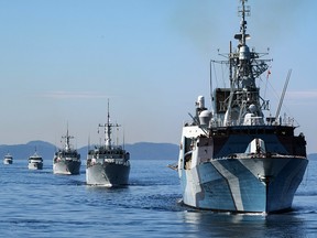 HMCS Regina (front) followed by HMCS Brandon, HMCS Naniamo, Patrol Craft Training vessel (PCT) Cougar and PCT Wolf, sail in formation in the Strait of Georgia on Canada’s west coast on April 14, 2020.