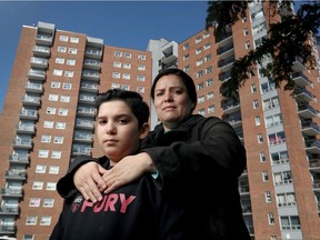 Maria Mendoza and her 11-year-old son, Mataeo, stand in front of 2850 Cedarwood Dr.