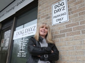 Janet Burns, owner of Dog Dayz, poses for a photo at her business on Friday.