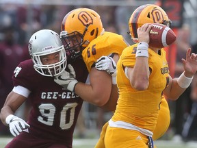 Ottawa Gee-Gees Alain Pae rushes Queen's Gaels quarterback Nate Hobbs during first half action in Ottawa Ontario Monday Sept 4, 2017.