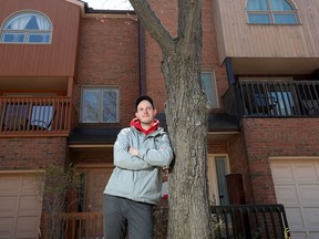 Eric Scharf poses for a photo in front of his new house in Ottawa Tuesday.