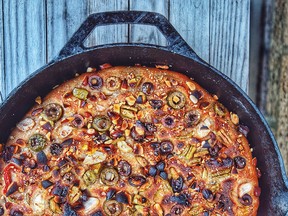 A yeasted spelt focaccia topped with olives, peppers, garlic and almonds.