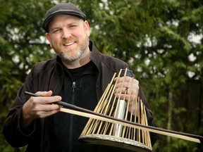 Carleton music professor Jesse Stewart plays a water phone outside of his Ottawa home.