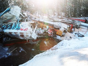 Wreckage of a CP Rail train lies in the Kicking Horse River east of Field, B.C., on Monday, Feb. 4, 2019. Three employees died in the derailment.