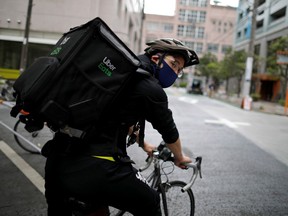 Japan's Olympic fencing medallist Ryo Miyake cycles as he works his part-time job as Uber Eats delivery person under a nationwide state of emergency as the spread of the coronavirus disease (COVID-19) continues in Tokyo, Japan May 12, 2020.