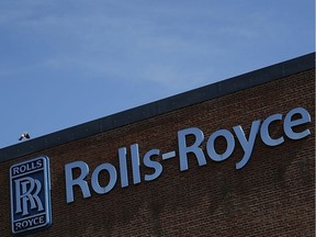 FILE: A Rolls-Royce Holdings Plc company logo sits on one of the company's manufacturing facilities in Derby, U.K., on Wednesday, May 20, 2020. Rolls-Royce Chief Executive Officer Warren East's five-year bid to revive earnings has been shattered by the coronavirus as the U.K. engineering giant moves to scrap 9,000 jobs and considers closing sites.