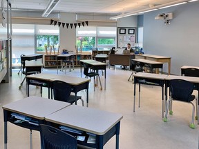 A classroom at a Vancouver school shows desks spaced out and many student chairs removed.